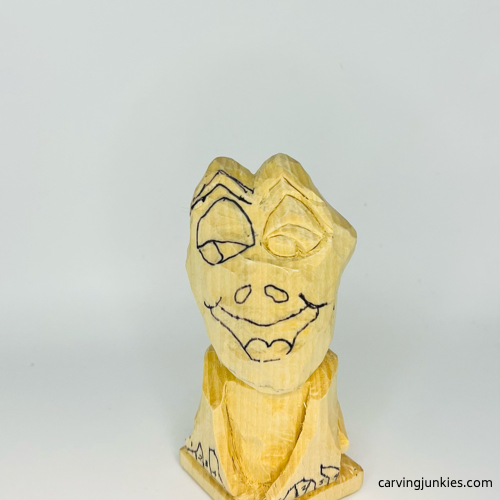 Eye completed on wooden frog carving