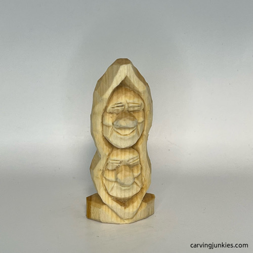 Completed facial details on pea pod wood carving Carved details on pea pod wood carving