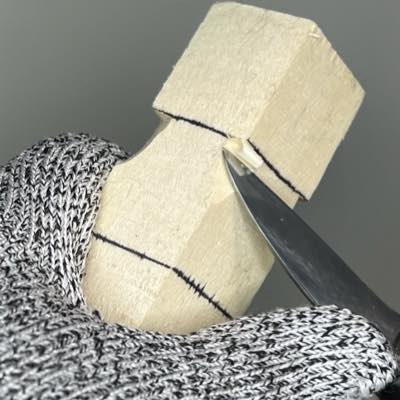 Separating top corners of acorn wood carving