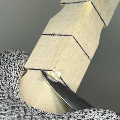 Separating bottom corners of acorn wood carving