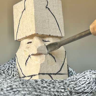 Shaping nose on acorn wood carving