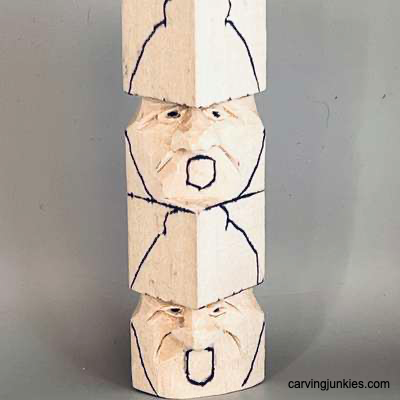 Mouths are sketched on acorn wood carving