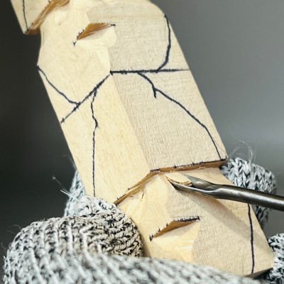 Using gouge on acorn wood carving caricature