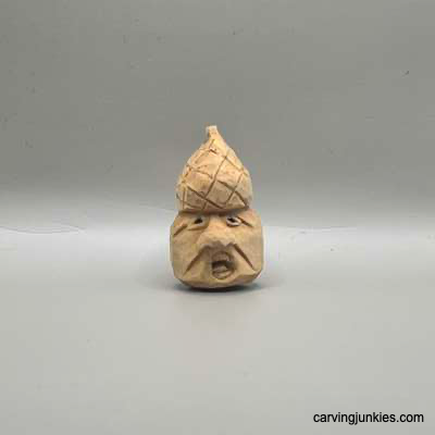 Front view of unpainted acorn carving