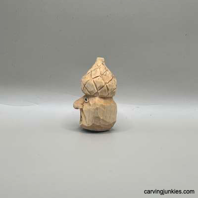 Left view of unpainted acorn carving