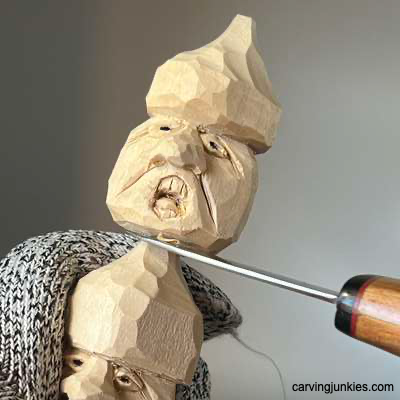 Separating two wooden acorn caricatures