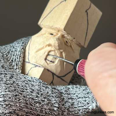 Starting the mouth on acorn wood carving caricature