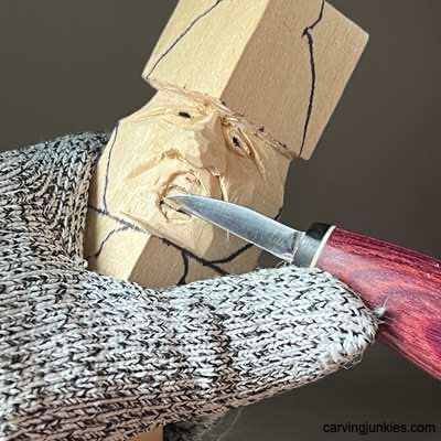 Removing wood to carve mouth on acorn wood carving caricature