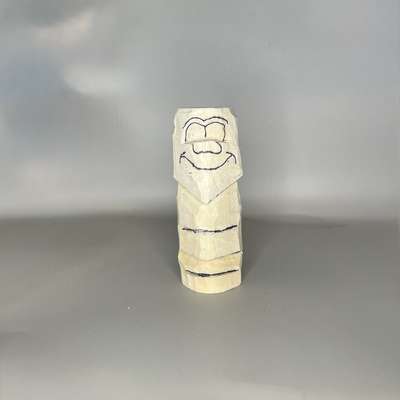 Facial details sketched on wood