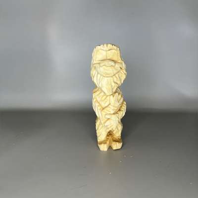Unpainted wood carving of Bigfoot