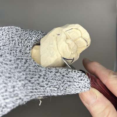 Carving the mouth on wooden Bigfoot