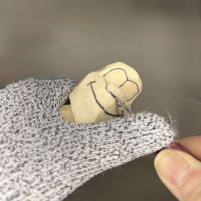 Carving nose on Bigfoot in wood