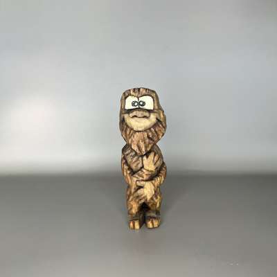 Front of painted wooden Bigfoot caricature