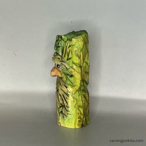 Left view of painted wood carved green man