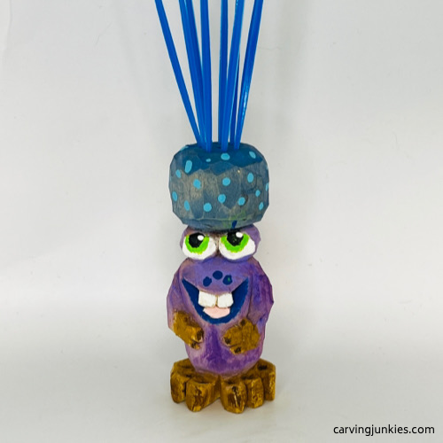 Front of painted carved monster toothpick holder