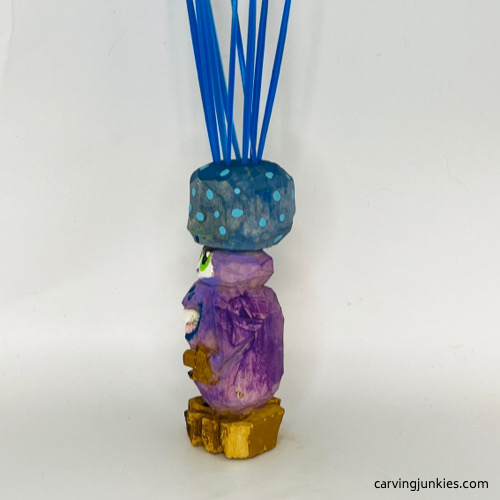 Left side of painted carved monster toothpick holder