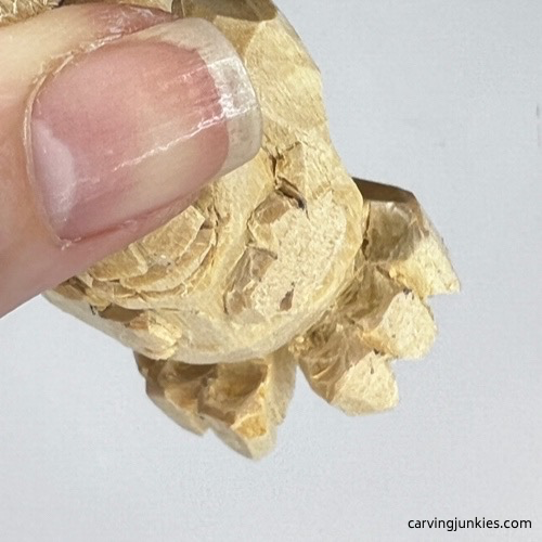 View of toes on carved monster toothpick holder