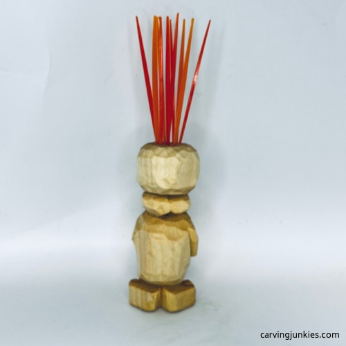 Back view of unpainted carved monster toothpick holder