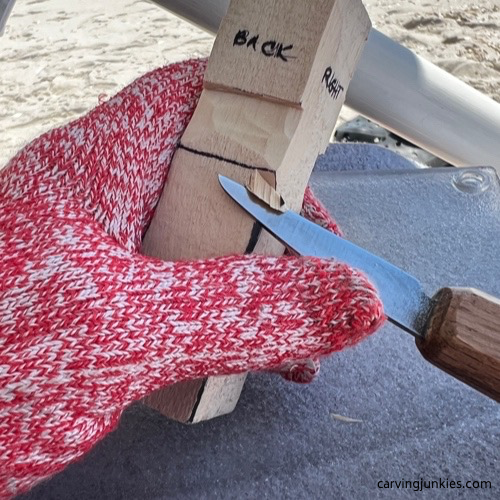 Removing wood from back of carved old man