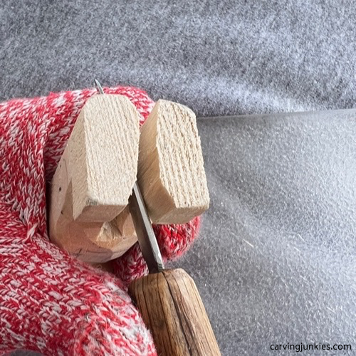 Cutting feet on carved old man