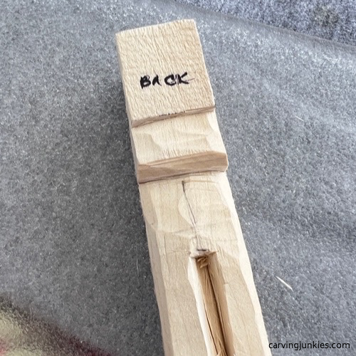 Legs separated on carved old man