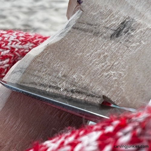 Making a stop cut on carved old man