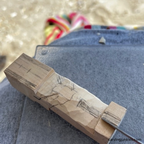 Splitting feet of carved old man with a V-cut