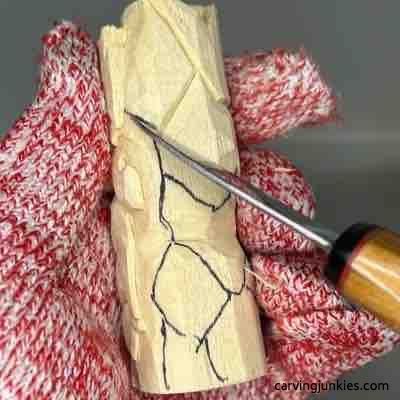 Carving back leaves on green man