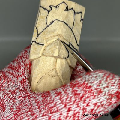 Carving nose on wooden green man