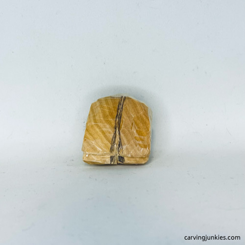 Marking wood for removal on front of wood carved fortune cookie