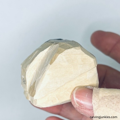 Progress shot of wood carved fortune cookie shaped on one side