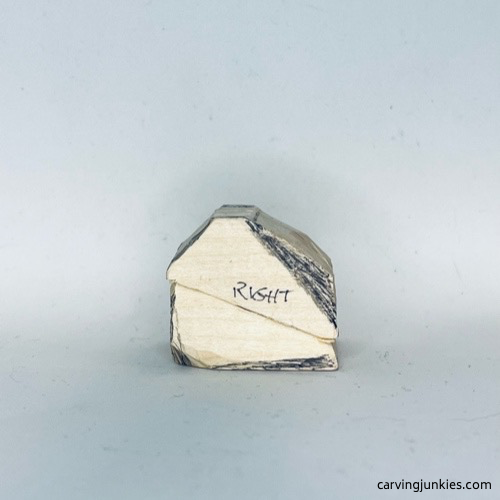 Right side of wood carved fortune cookie is marked for shaping