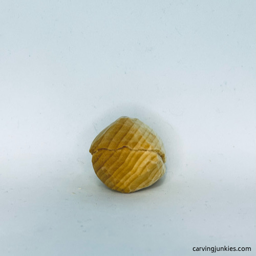 Back view of unpainted wood carved fortune cookie