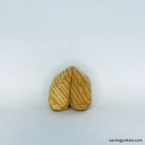 Font of unpainted wood carved fortune cookie