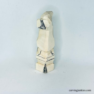 Details are sketched on back of wooden Christmas gnome