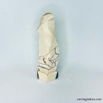 Details are sketched on right side of wooden Christmas gnome