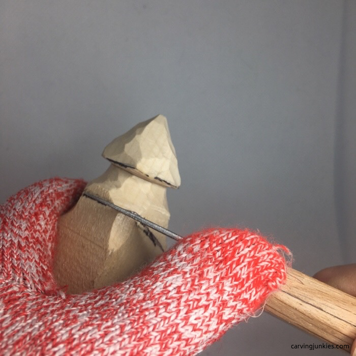 Carving wooden tree with a knife