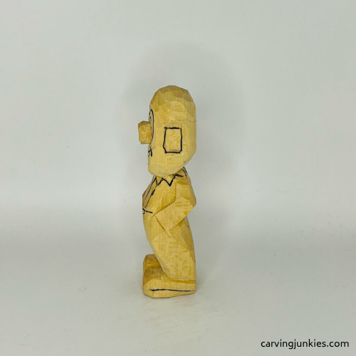 Left side of drawn details on wooden circus clown Left view of drawn details on wood circus clown