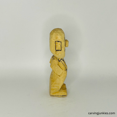 Right side of drawn details on wooden circus clown Right view of drawn details on wood circus clown