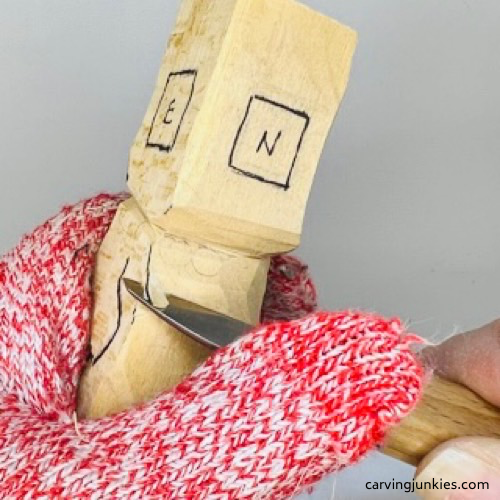 Carving front shoulders on wooden circus clown Shaping front shoulders on wood circus clown