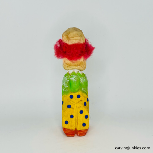 Back side of painted wooden circus clown Back view of painted wood circus clown