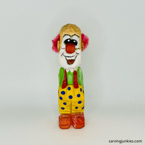 Front side of painted wooden circus clown Front view of painted wood circus clown