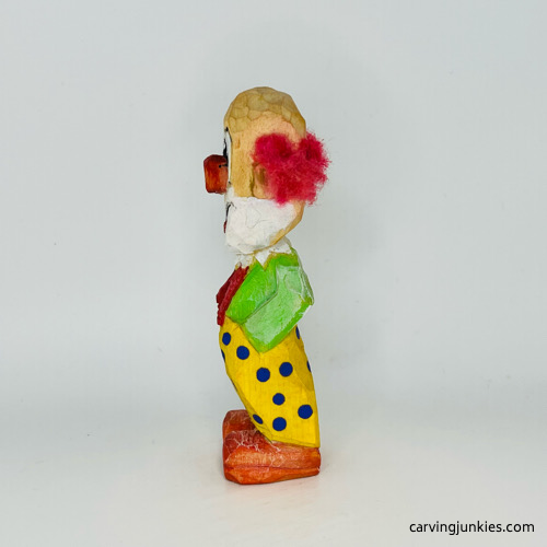Left side of painted wooden circus clown Left view of painted wood circus clown