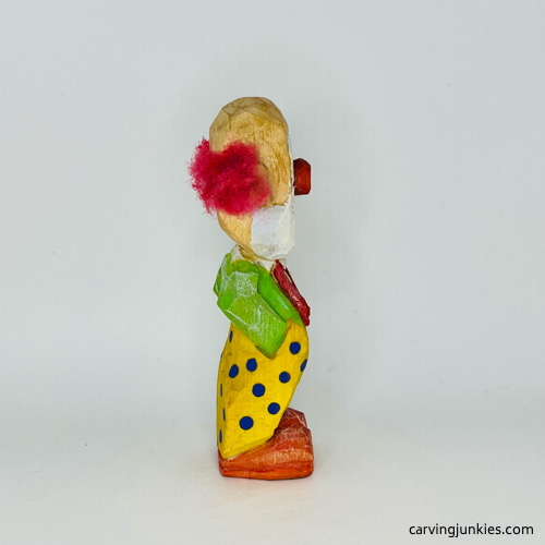 Right side of painted wooden circus clown Right view of painted wood circus clown