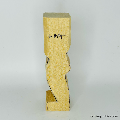 Left side of carved clown roughout from wood Left view of carved wooden clown roughout