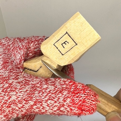 Carving front shoulders on wooden circus clown Cutting front shoulders on wood circus clown