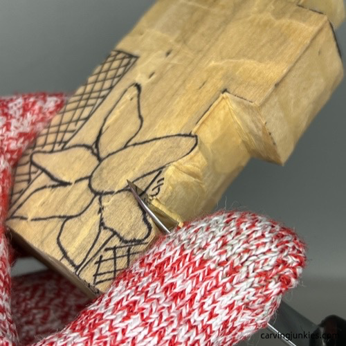 Separating a flower with a knife to carve a decorative wood cross