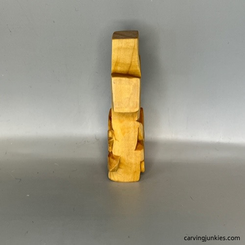 Completed left side of wooden cross carving before painting