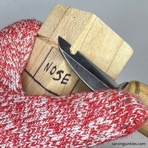 Cutting eyes on wood carved dog