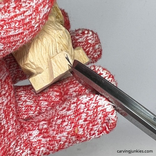 Carving paws on carved wooden dog